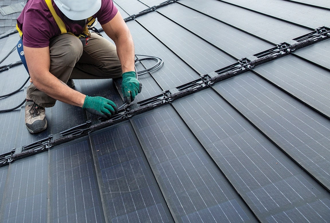 Worker installing solar panels